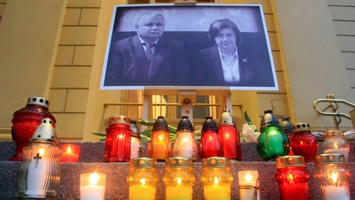 Kerzen stehen vor einem Foto des polnischen Präsidenten-Ehepaares Kaczynski