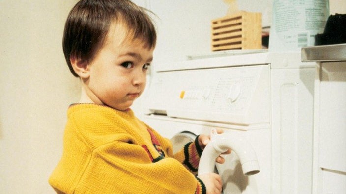 "Tiger" Tom (Johannes Scheit) spielt mit dem Abwasserschlauch der Waschmaschine und verwandelt dabei die Küche in einen Swimingpool.