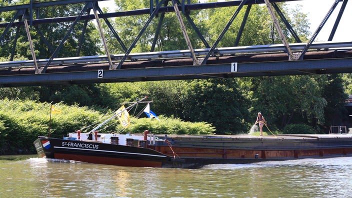 Ein Binnenschiff fährt auf dem Rhein-Herne-Kanal unter einer Brücke durch
