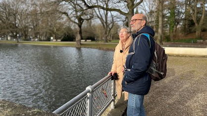 Rita Erken und Bernhard Fröhlig aus dem Verein Öcher Frönnde in Aachen stehen in einem Park