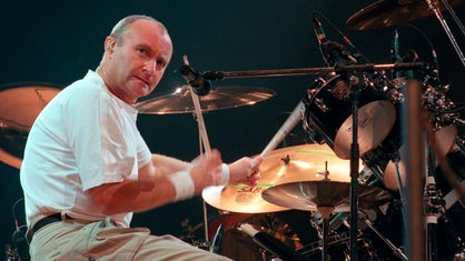 Phil Collins sitzt bei einem Konzert in Frankfurt im Jahr 1997 am Schlagzeug