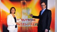 Sandra Maischberger und Kurt Krömer vor dem Logo 'Der Deutsche Fernsehpreis'
