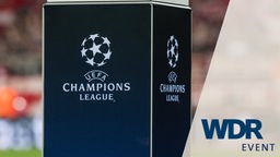 UEFA Champions League-Logo auf Podest im Stadion, Bild mit WDR Event-Logo
