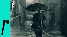 Eine Person mit Regenschirm läuft in der Nacht.