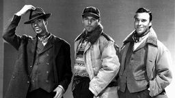 Drei Männer posieren auf Werbebild für die Internationale Herren-Mode-Woche 1996/97