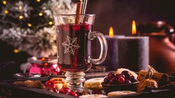 Ein warmes Getränk mit Kerzen und weihnachtlicher Dekoration