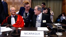 Der nicaraguanische Botschafter Carlos Jose Arguello Gomez und Rechtsanwalt Alain Pellet sitzen im Gerichtssaal des Internationalen Gerichtshof in Den Haag. 