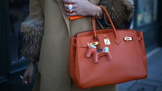 Eine Frau trägt eine Birkin Bag zur Fashion Week in Paris 2019