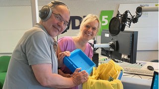 Helmut Gote und Julia Schöning packen die Kochkiste aus
