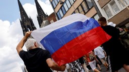 Bei einer pro-russischen Demonstration mit Umzug durch die Kölner Innenstadt schwenkten die Teilnehmer die russische Flagge.