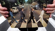 Zwei Hände halten auf der Abbey Road das Album "Abbey Road" in der Hand
