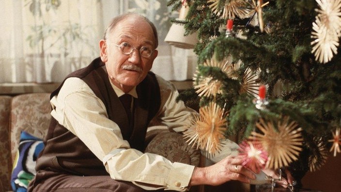 Hubert (Robert Zimmerling) repariert den Weihnachtsbaumständer.