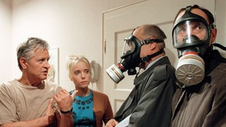 Maskenball bei Zenkers: Andy (Jo Bolling, links) und Valerie (Nadine Spruß) sind fassungslos, als zwei Männer mit Schutzmasken in der Tür stehen.