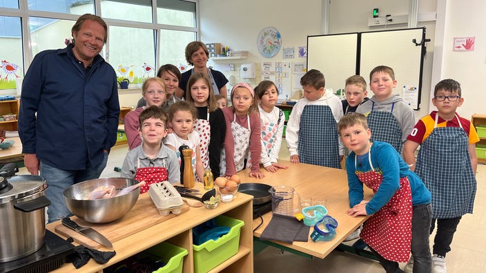 Das Bild zeigt Björn Freitag mit der Koch-AG der Grundschule Hackenberg.