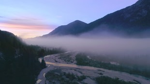 Eine Luftaufnahme der Isar von oben im Nebel