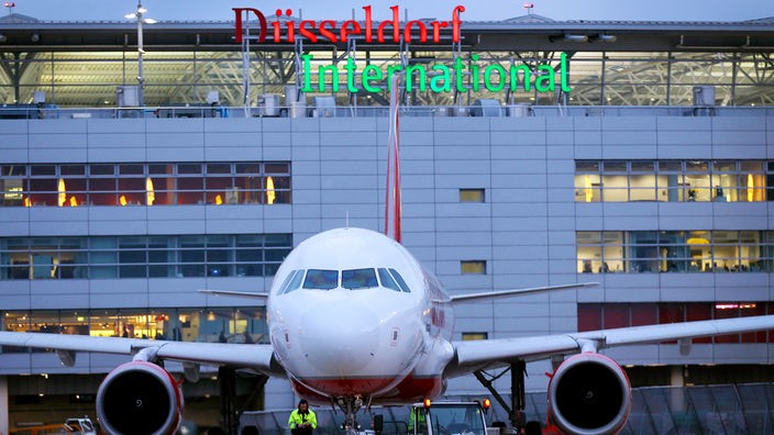 Flugzeug vor Leuchtschrift Düsseldorf International