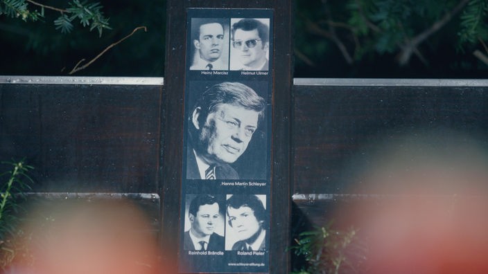 Eine Gedenkstele mit Fotos von Hanns-Martin Schleyer und weiteren Opfern am Gedenkort in Köln-Braunsfeld