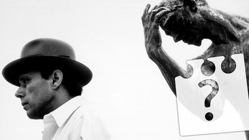 Joseph Beuys vor der Figur des Pierre de Wissant aus Rodins "Die Bürger von Calais" und Fragezeichen im Bild