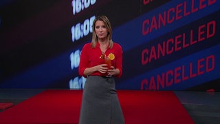 Catherine Vogel steht mit einem Getränk in der Hand im Markt-Studio. Im Hintergrund sieht man die Anzeigetafel eines Flughafens.