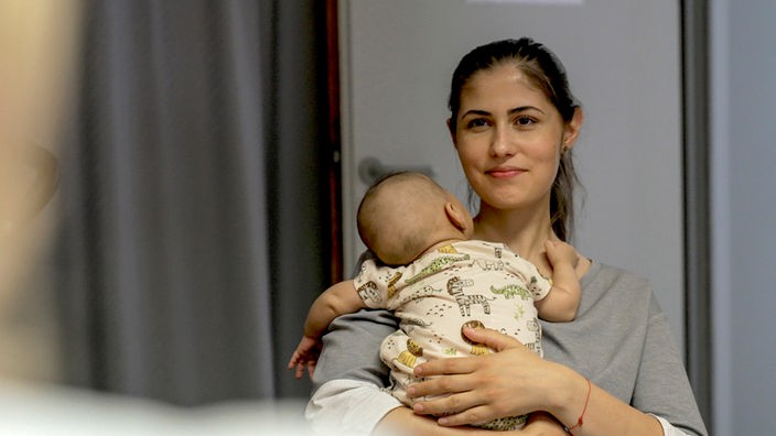 Frau mit Kind auf dem Arm