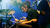Drummer von "The Joy Formidable" spielt mit geschlossenen Augen Schlagzeug.