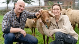 Das Bild zeigt Stefan Schmitz und Dunja Berendsen mit einem Schaf in der Mitte.