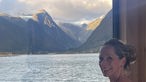 Tamina Kallert schaut aus einem Fenster auf Wasser und Berge des Fjords