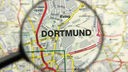 Lupe über Landkarte, die Stadt Dortmund ist groß gekennzeichnet