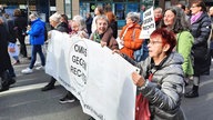 Ältere Frauen laufen bei einer Demo und tragen ein Banner mit der Aufschrift "Omas gegen Rechts"