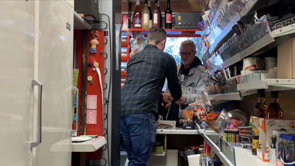Ein Mann bedient einen Kunden im Kiosk Mummel.