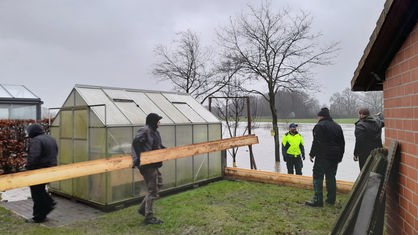 Helfer bauen die Hochwasserschutzwand auf dem Hof von Tobias Beermann in Haltern am See auf