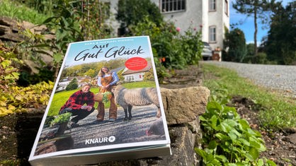 Das Buch "Auf Gut Glück", das Familie Niedrig geschrieben hat, liegt vor dem Gutshof in der Eifel