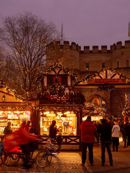 Eine leuchtende Hütte im Fachwerkstil auf dem Weihnachtsmarkt in Köln