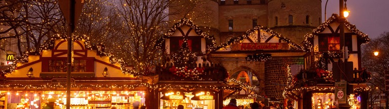 Eine leuchtende Hütte im Fachwerkstil auf dem Weihnachtsmarkt in Köln