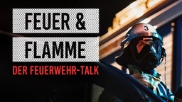 Zwei Feuerwehrleute vor Flammen