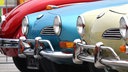 2 VW Karmann-Ghia Typ 14 und dahinter ein legendärer VW-Käfer auf der Retro Classics 2016, Europas größte Oldtimermesse.