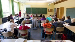 Eine 8. Klasse sitzt in einem Klasssenraum in der Realschule während des Mathe-Unterrichts. 