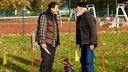 Eine Mann bedroht einen anderen Mann während des Hundetrainings mit einem Messer