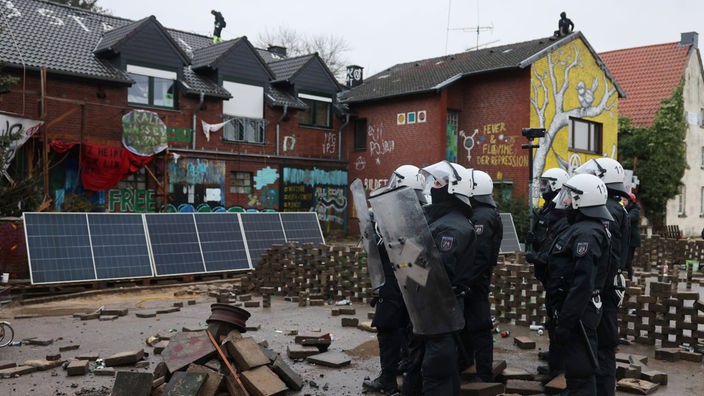 Polizisten rücken in den von Klimaaktivisten besetzten Braunkohleort Lützerath durch Barrikaden vor.