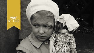 Ein Kind hält eine Puppe im Arm