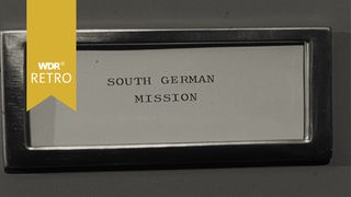 Schild mit Aufschrift "South German Mission"