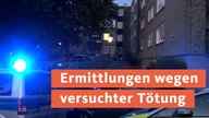 Polizeieinsatzwagen vor einem Wohnungskomplex