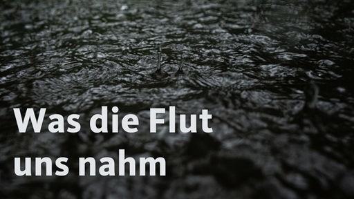 Wasserstropfen spritzen bei Regen von der dunklen Oberfläche eines Gewässers auf. In einem Schriftzug ist der Satz "Was die Flut uns nahm" lesbar.
