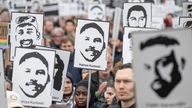 Menschen ziehen bei einem Gedenkmarsch anlässlich des vierten Jahrestages des rassistische Anschlags von Hanau durch die Innenstadt