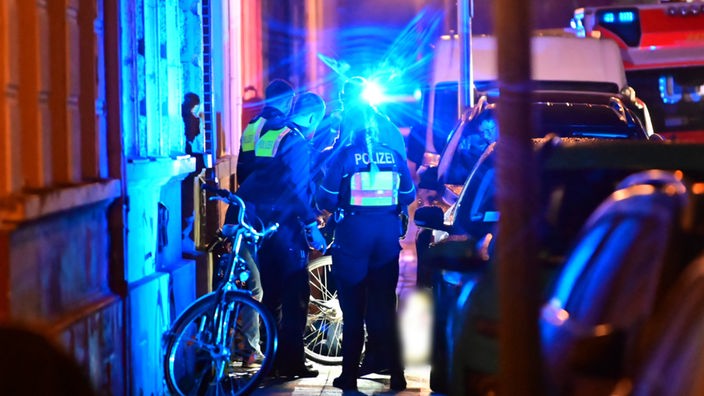 Krefeld: Polizisten stehen auf einem Gehweg neben dem Toten.
