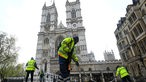 People work as they prepare the ground in front of Westminster Abbey 