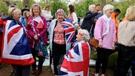 People wait on The Mall, ahead of the coronation of Britain's King Charles and Queen Camilla, in London