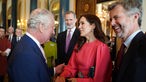 King Charles III greets Mary, Crown Princess of Denmark and Crown Prince Frederik of Denmark, at a Coronation reception at Buckingham Palace in London.