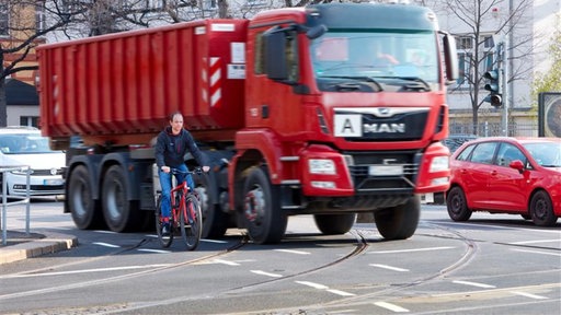 Fahrradfahrer fährt neben LKW im toten Winkel