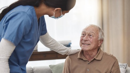 Aufnahme einer jungen Krankenpflegerin mit einem älteren Patienten